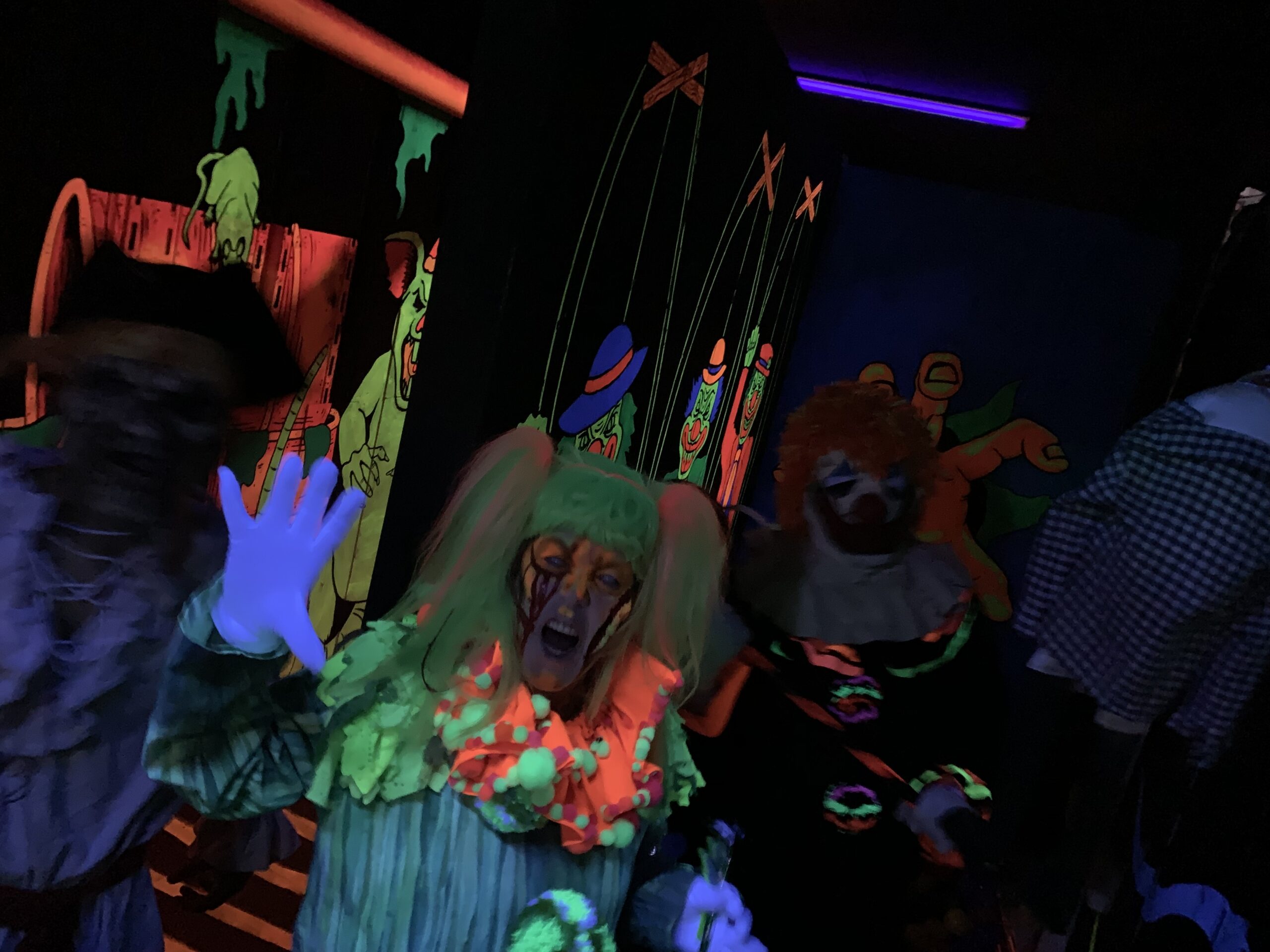 Neon Clown Character in Haunted Attraction Room at Terror in the Corn