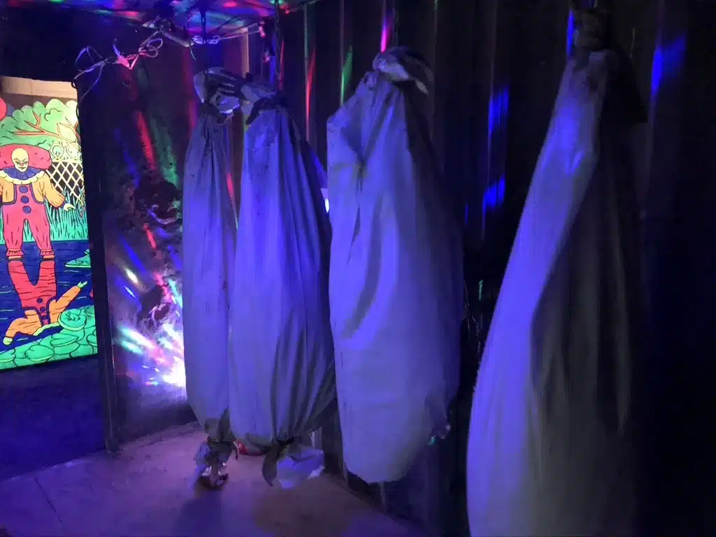 Body Bags Hanging from Ceiling Inside Haunted House with Glowing Lights at Tucson Terror in the Corn