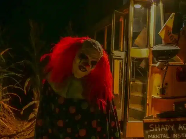 Creepy Clown Staring Outside Yellow Bus at Tucson Terror in the Corn