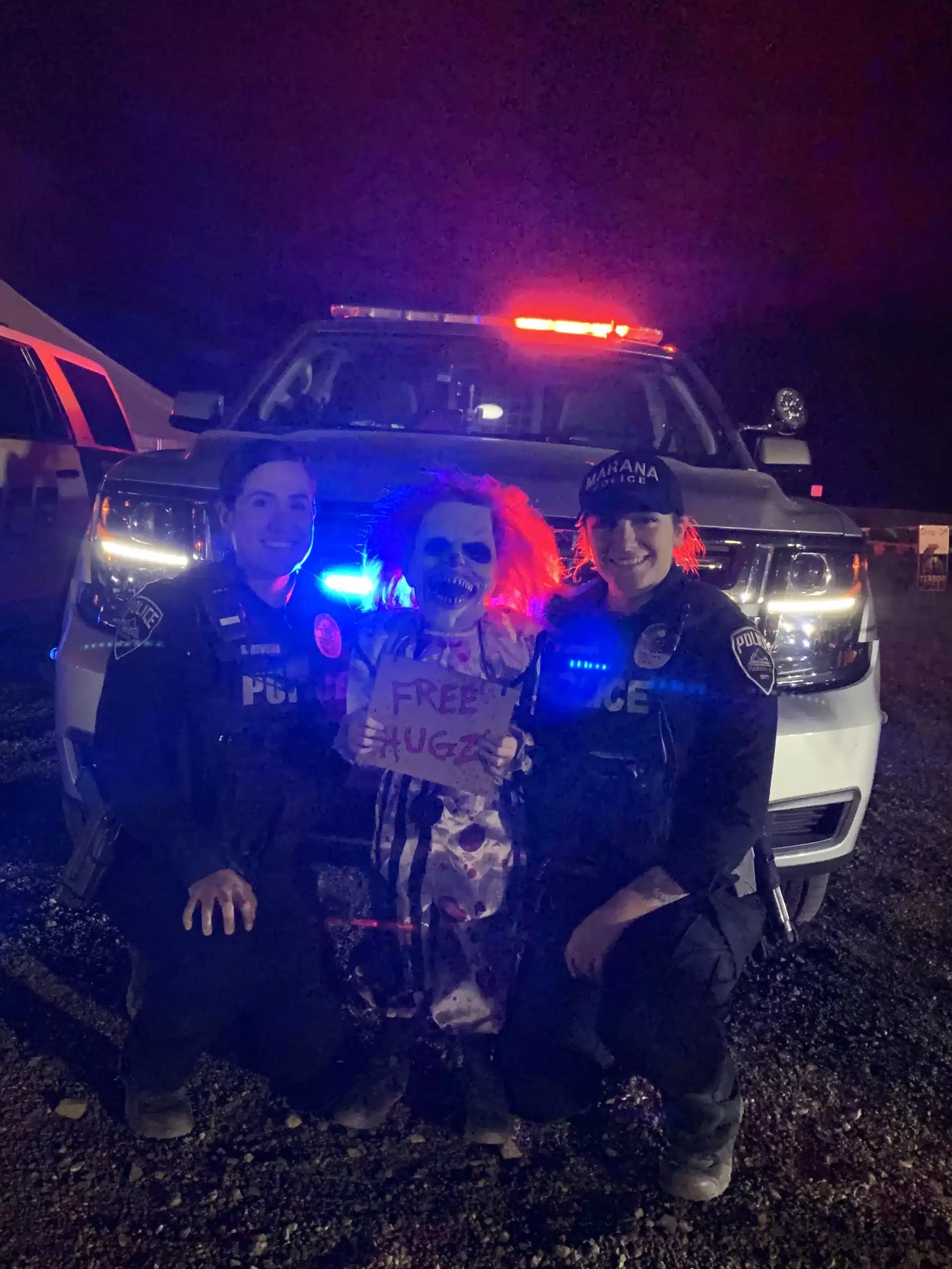 Marana Police Officers Smiling for a Picture Next to a Scary Clown with 