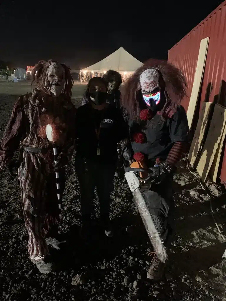 Scary Characters in Masks Holding a Chainsaw at Tucson Terror in the Corn